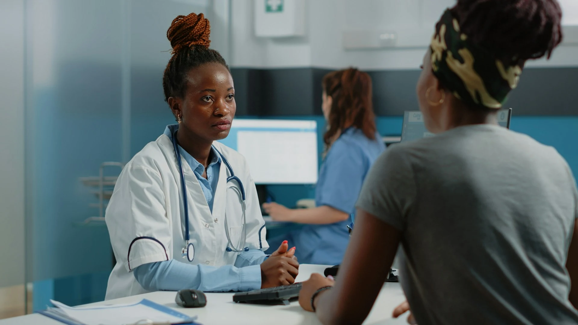 Doctor handing a small medication packet to a patient